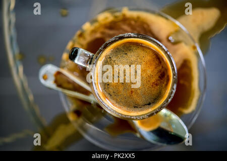 above view of coffee cup with spilled coffee on table Stock Photo