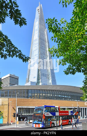 Open top double decker red white and blue London sightseeing tour bus & The Shard landmark skyscraper building Tooley Street Southwark South London UK Stock Photo