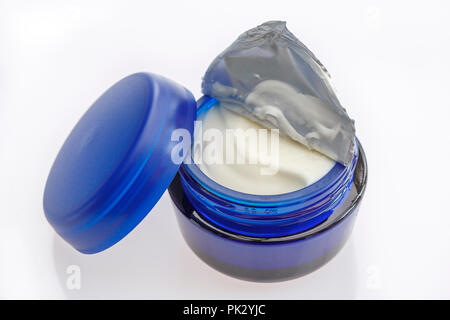 New open blue jar of moisturising face cream isolated on a plain white background Stock Photo