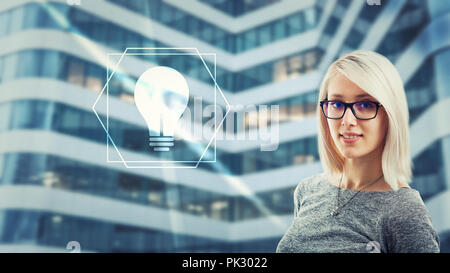 Beautiful woman wearing eyeglasses looking at camera having idea as light bulb icon glow on digital screen interface. Creativity artificial intelligen Stock Photo