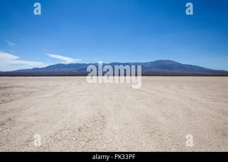 Mojave desert dry lake with mountain backdrop near Death Valley in California. Stock Photo