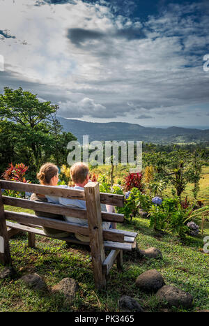 Couple enjoying the view from Mirador El Silencio Hotel, San Carlos, Costa Rica Stock Photo