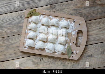 Traditional dish of russian cuisine. Pelmeni on a cutting board Stock Photo