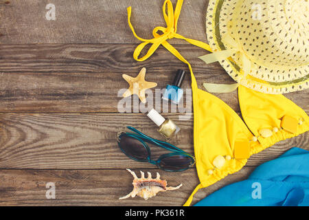 Summer accessories on wooden old background. Top view. Toned image. Stock Photo
