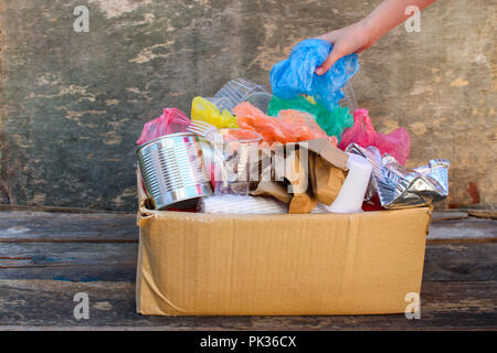 Box with trash on wooden background Stock Photo