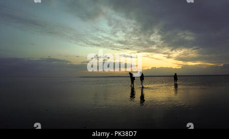 People on salt lake  at sunset Stock Photo