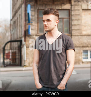 Portrait of young man standing on the street. Stock Photo