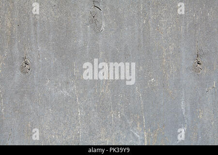 Sheet of plywood, painted in light gray color wiped and scratched, surface texture for background. Stock Photo