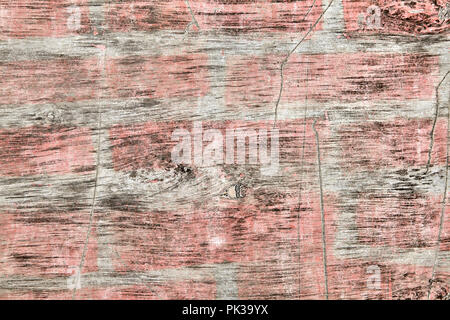 Dirty, old plywood sheet with spots of faded pink paint, scratched and worn, textured surface for the backdrop. Stock Photo