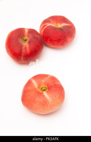 Flat peaches Saturn peach isolated on a  white studio background. Stock Photo