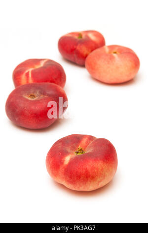 Flat peaches Saturn peach isolated on a  white studio background. Stock Photo
