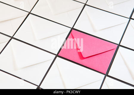 Composition with white and pink envelopes on the table. Different colored envelopes on the table. Stock Photo