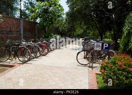 A busy cycle rack outside a garment factory in Bangladesh. Stock Photo