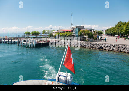 Passenger boat with Swiss flag departing Lausanne Ouchy port, Switzerland on Lake Leman (Geneva Lake) on sunny summer day Stock Photo