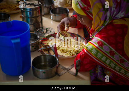 Garment workers having their lunch in the canteen at a garment factory in Bangladesh. Stock Photo