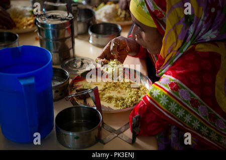 Garment workers having their lunch in the canteen at a garment factory in Bangladesh. Stock Photo