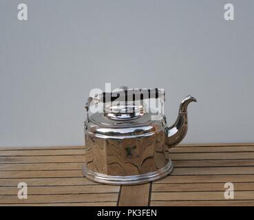 Rare aluminum water kettle on wooden background Stock Photo