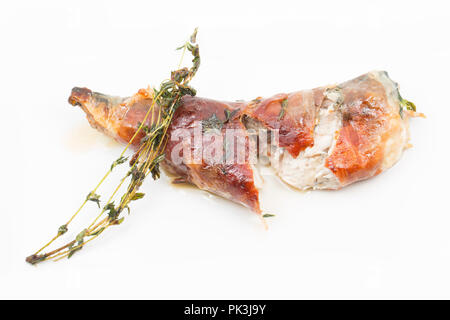 Two mackerel fillets, Scomber scombrus, that have had Parmesan cheese placed between them before being wrapped in Parma ham and then fried in butter a Stock Photo