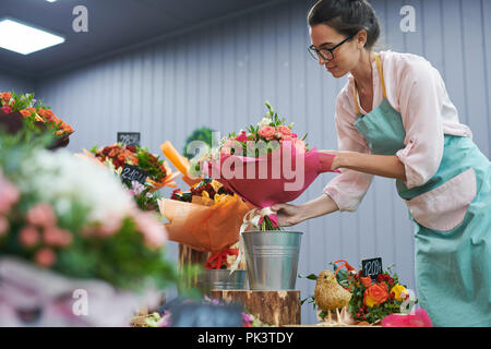 Florist Working in Shop Stock Photo