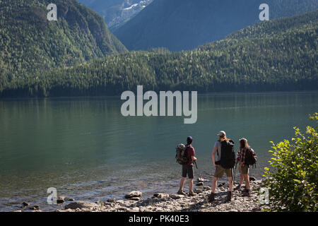 Hikers standing near riverside Stock Photo