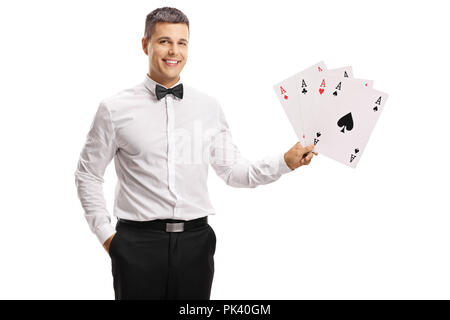 Handsome young man in a tux holding playing cards isolated on white background Stock Photo