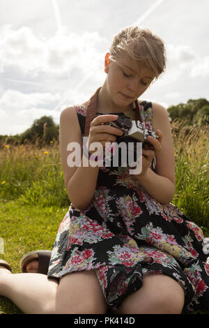 Woman reviewing photos on camera Stock Photo