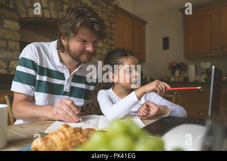 Father and daughter using laptop Stock Photo