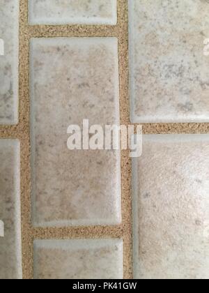 Closeup of small rectangular light brown tile surface. Stock Photo