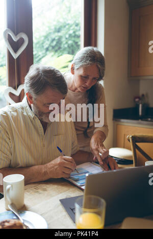 Senior couple checking invoices Stock Photo