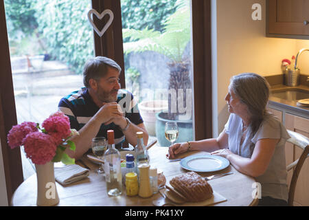 Senior couple interacting with each other on dining table Stock Photo