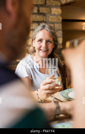 Senior couple interacting with each other on dining table Stock Photo
