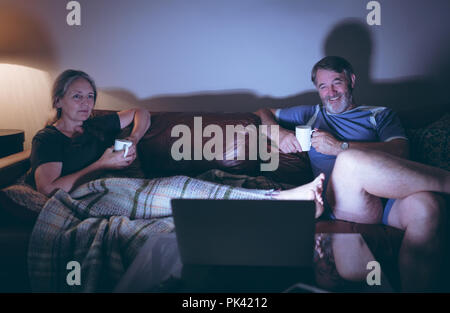 Senior couple watching laptop while having coffee Stock Photo