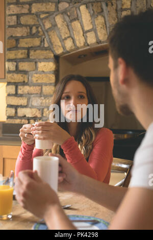 Couple interacting with each other while having coffee Stock Photo