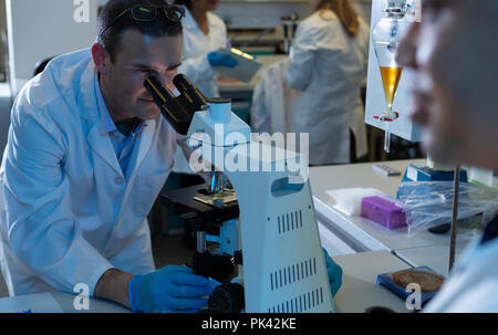 Male scientist using microscope Stock Photo