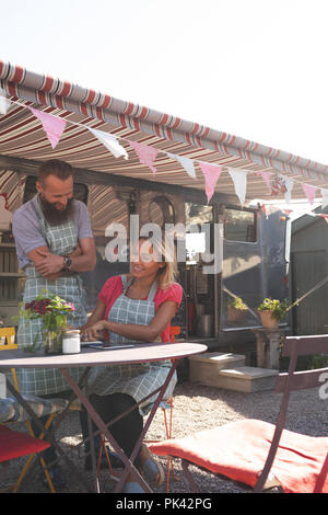 Couple working near food truck Stock Photo