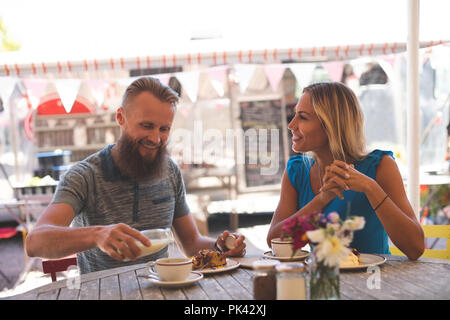 Couple having breakfast in outdoor cafe Stock Photo