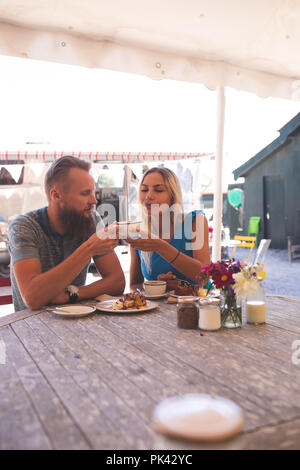 Couple having coffee in outdoor cafe Stock Photo
