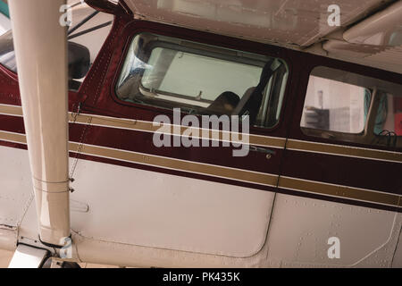 Airplane parked in aerospace hangar Stock Photo