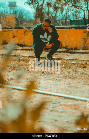 Man modeling at abandoned train station Stock Photo