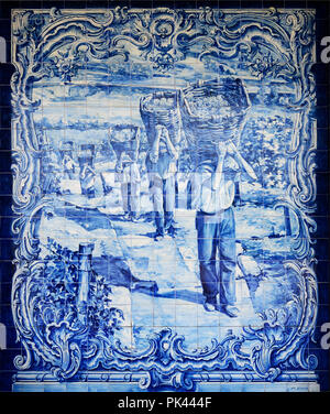 Traditional blue tiles (Azulejos) depicting the harvest related with the Port Wine. Railway station of Pocinho, Alto Douro. A Unesco World Heritage Si Stock Photo