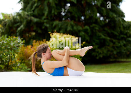 Girl practicing Yoga outdoors Stock Photo