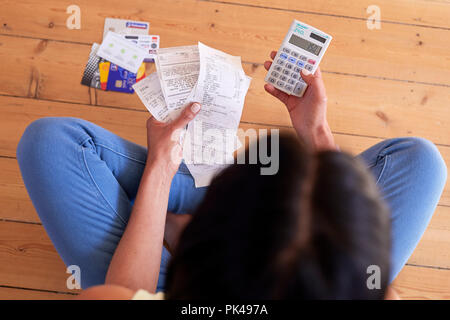 Woman looking at bills Stock Photo