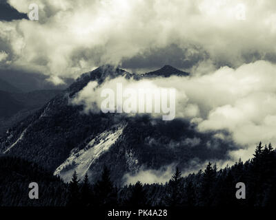 Mountains peaks in stormy and cloudy and foggy environment Stock Photo
