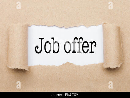 Job Offer concept text appearing behind torn brown paper envelope Stock Photo