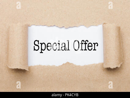 Special Offer concept text appearing behind torn brown paper envelope Stock Photo