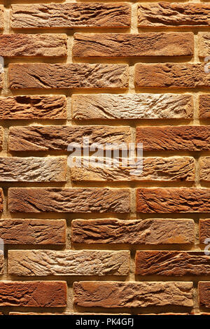 Vintage brown cracked brick wall texture. Vertical brick wall background. Stock Photo