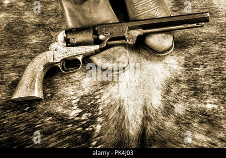 Cowboy boots and western cowboy pistol in black and white. Stock Photo