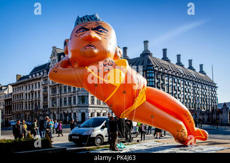 Protesters Fly a 29ft Long Bikini-Clad Blimp of London Mayor Sadiq Khan Over Parliament Square, London, UK Stock Photo