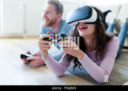 Young couple playing games with virtual reality headset Stock Photo