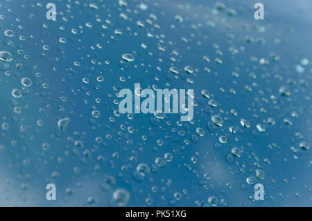 Drops of rain falling down on the car glass Stock Photo
